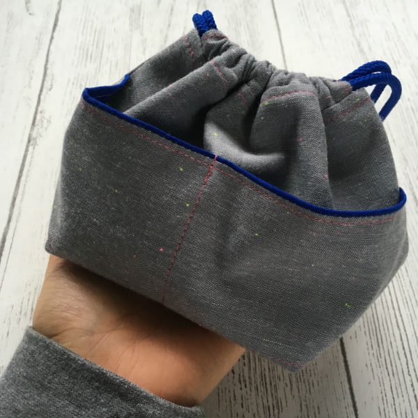 hand holding a drawstring bag
