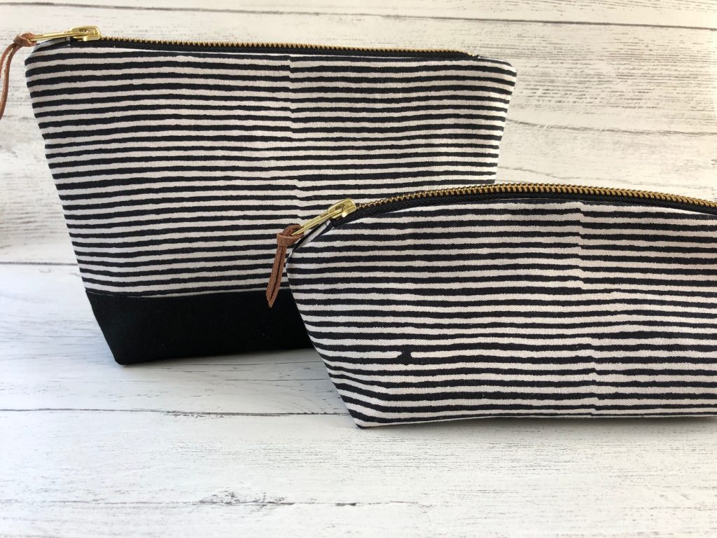 two make up bags in a black and white striped fabric